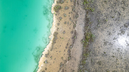 Bacalar, Mexico, Quintana Roo, Blue ocean with a sandy beach and a rocky shoreline