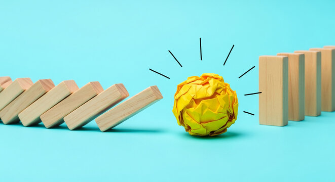 Wooden dominoes falling towards yellow paper ball on blue surface, suggesting disruption and new idea, representing influence, obstacle, potential impact - Powered by Adobe