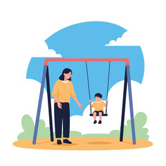 Fototapeta premium A caring mother gently pushes her young son on a playground swing under a bright blue sky.