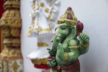 Ganesha statue, revered Hindu deity, symbol of wisdom and prosperity. Green elephant god idol,...