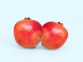 Two Fresh Pomegranates on the Blue Background