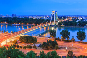 Bratislava, Slovakia. UFO or The SNP bridge over the Danube river with night panorama of Bratislava.