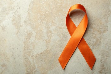 Orange Awareness Ribbon on Textured Beige Background Symbolizing Support and Solidarity