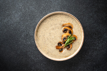 Mushroom soup puree on white kitchen table.
