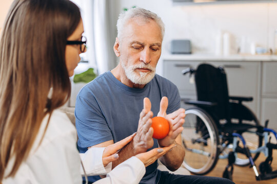 Senior man doing rehabilitation exercises with doctor