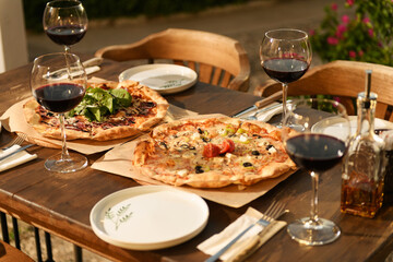 Closeup of Wooden Table with Pizza and Wine