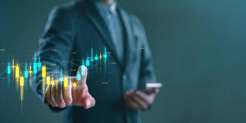 Businessman or trader analyzing digital candlestick chart on virtual screen, representing stock trading, financial investment, market analysis, forex, crypto, and economic data visualization.
