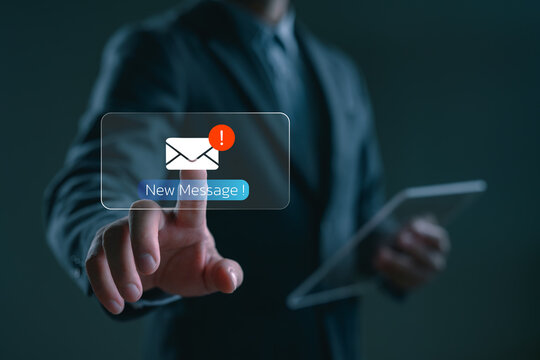 Businessman touching new message notification icon on virtual screen, representing digital communication, email alert, online messaging system, instant response, and business connectivity.
