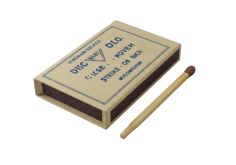 Elegantly aged cardboard matchbook with faded blue text 'CLOSE COVER • STRIKE MATCH ON BACK' and a wooden matchstick, isolated on transparent, soft studio light. Concept of vintage product photography