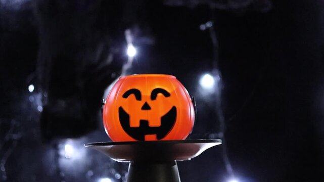 Un primer plano de una calabaza de halloween con un fondo negro con luces desenfocadas. Feliz halloween