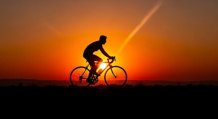 Obraz premium Man Cycling at Sunset.