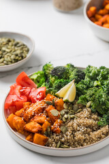 Healthy vegan Buddha bowl with quinoa, pumpkin and seasonal vegetables. Vegetable recipes.