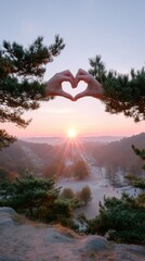 Hands Forming Heart Shape Over Sunset Scenery with Forest Silhouette and Pink Sky