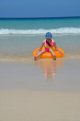 girl on a yellow circle by the sea