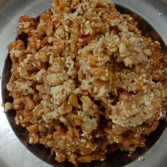 Indian traditional sweet made of sesame seeds, jaggery and peanuts served in steel plate, crunchy festive dessert commonly prepared during festivals like Makar Sankranti.