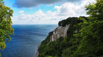 The majestic chalk cliffs (Kreidefelsen) in Jasmund National Park on the island of R&uuml;gen, Germany. The white cliffs plunge into the Baltic Sea, framed by lush vegetation.
