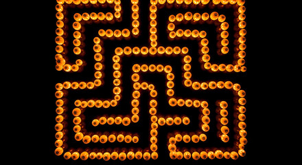 a pumpkin patch designed like a labyrinth. The paths are dark, the pumpkins glow