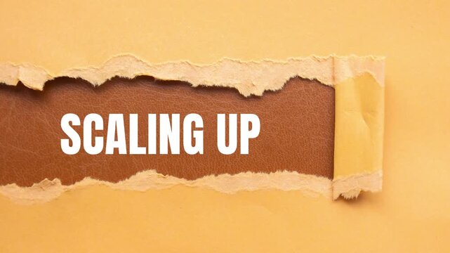 Scaling Up message written on ripped torn paper background
