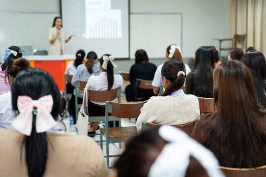 Students Listening to Teacher Presentation in Classroom

