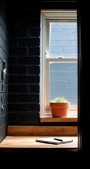 A window seat nook, featuring a terracotta pot plant and a simple notebook on a light-colored wooden surface, is bathed in soft light.