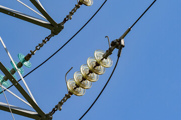 Close up view of the insulators on high voltage power lines on pylons which form the national...