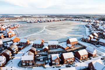 England suburban housing estate winter snow aerial view