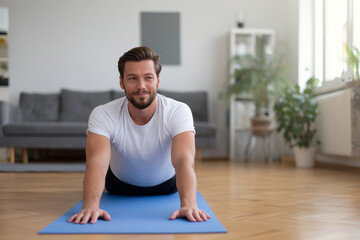 Fototapeta premium Young man practicing yoga at home in a peaceful environment