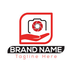 Red camera lens aperture on open hand inside rounded square logo with brand name text tagline