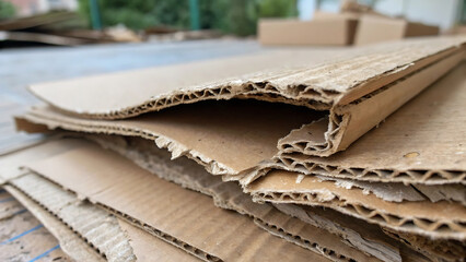  Close up of stacked corrugated cardboard sheets on a blurred background