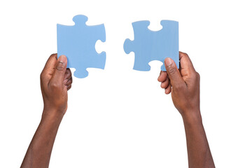 Man holding and matching two pieces of jigsaw puzzle, isolated on white or transparent background