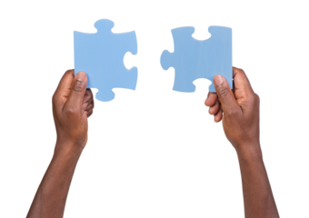 Man holding and matching two pieces of jigsaw puzzle, isolated on white or transparent background