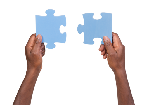 Man holding and matching two pieces of jigsaw puzzle, isolated on white or transparent background