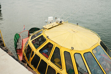 Close-up of colorful yellow and green boat docked on the Sava River in Belgrade. A tourist boat...