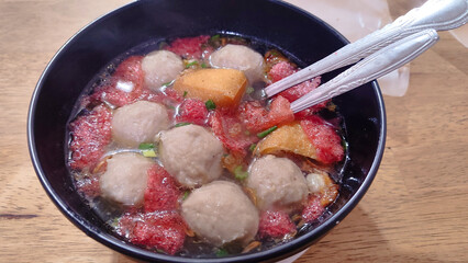 Bakso Malang is a traditional Indonesian dish from the city of Malang. The broth contains beef meatballs, chicken dumplings, tofu, shredded chicken, and crackers.