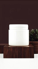 White jar with lid on wooden block next to succulent plant
