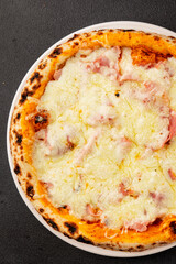 Pizza ham, cheese, tomato sauce fast food natural product tasty snack fresh delicious gourmet food background on the table rustic top view copy space
