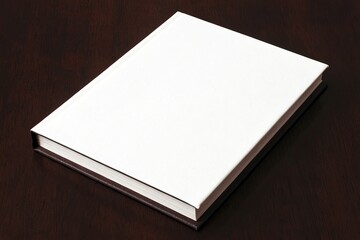 Blank white book cover on dark wood surface
