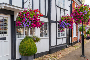 Old historic houses decorated with flower baskets in Old Amersham in Buckinghamshire, UK © beataaldridge