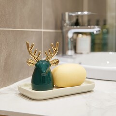 A charming, decorative reindeer figurine and a pale yellow soap dish rest on a minimalist tray in a modern bathroom.