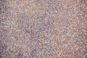 texture of small colorful pebbles on a gravel surface.