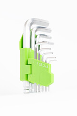 Close-up of green hex key wrench set with multiple sizes, isolated professional repair tool collection.