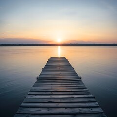 Naklejka premium Tranquil wooden pier leads to a serene sunset over a calm lake landscape at dawn