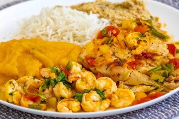 Moqueca capixaba is a typical dish from Espírito Santo, Brazil, made with ocean fish and shrimp. It's cooked gently and flavorfully in a clay pot without the use of palm oil or coconut milk.