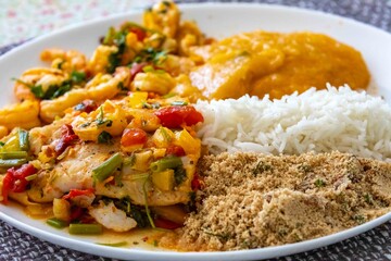 Moqueca capixaba is a typical dish from Espírito Santo, Brazil, made with ocean fish and shrimp. It's cooked gently and flavorfully in a clay pot without the use of palm oil or coconut milk.