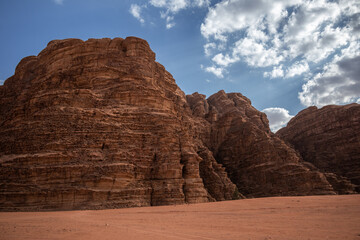 Rocky Mountain Formation with Desert Sand in Wadi Rum, Jordan. The Arid Landscape shows Dramatic Sandstone Cliffs in the Middle East.