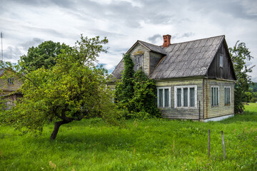 Zapyskis Town in Kaunas District, Lithuania. Old Wooden House with Apple Tree Garden in Backyard.