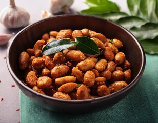 spicy deep fried peanuts flavored with curry leaves and garlic served in a bowl