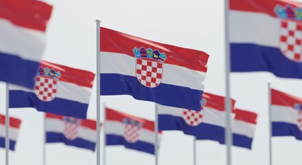 Multiple flags of croatia waving in the wind against a clear sky, patriotism concept.