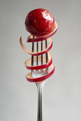 Red Apple on a Fork with Spiral Peel – Creative Fruit Concept Made with generative AI
