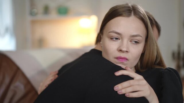 A couple displays a variety of emotions in a warm, cozy indoor setting filled with love and intimacy